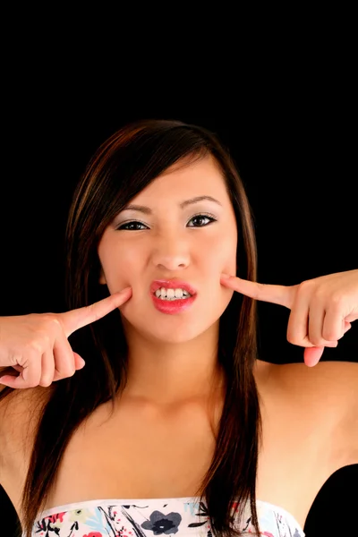 Teen Asian American Woman fingers to cheeks — Stock Photo, Image