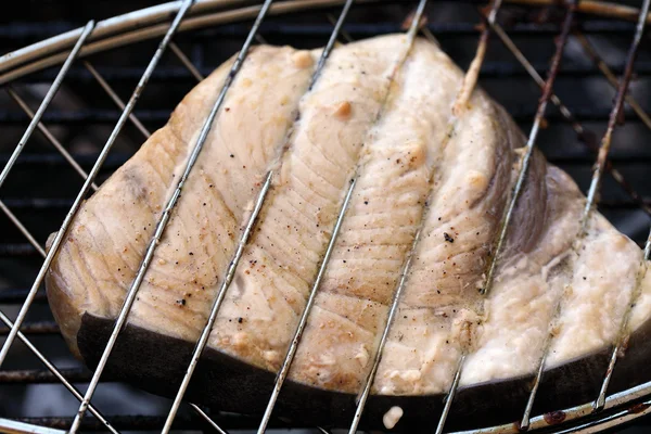 Swordfish steak cooking on barbecue grill closeup — Stock Photo, Image