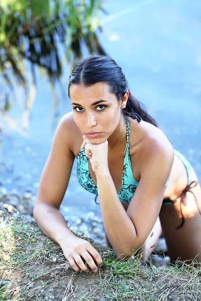 Young woman on river bank in bikini portrait — Stock Photo, Image