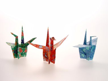 Three Oragami Cranes of different colors clipart