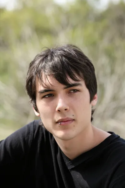 Young teen boy outdoor portrait black hair — Stock Photo, Image