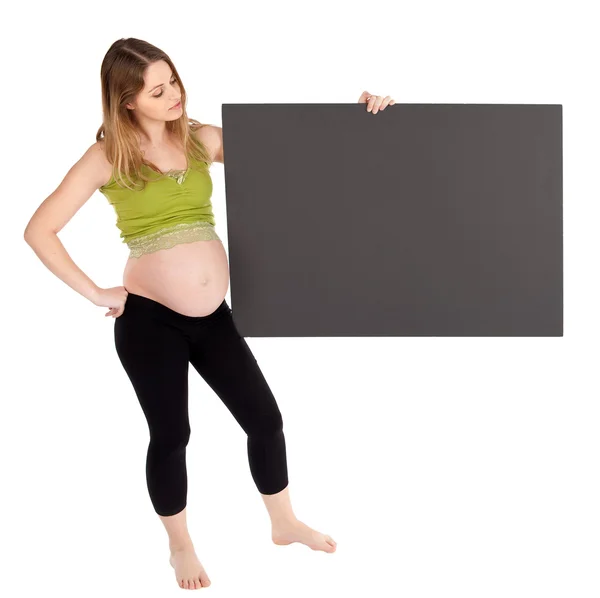Беременная женщина держит пустую доску — стоковое фото