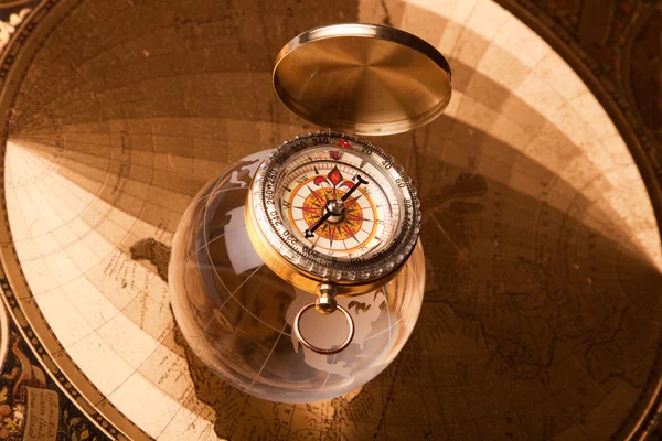 Gold compass on gold map — Stock Photo, Image