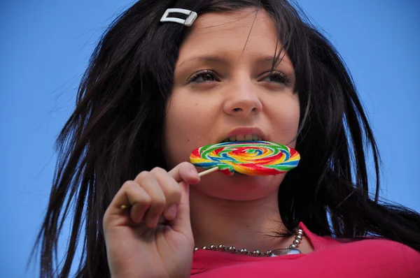 Girl with lollipop and blue sky — Stock Photo, Image