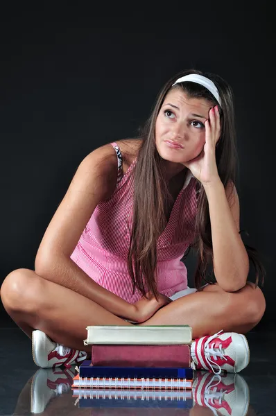 Schoolgirl sitting in front of her books — Stock Photo, Image