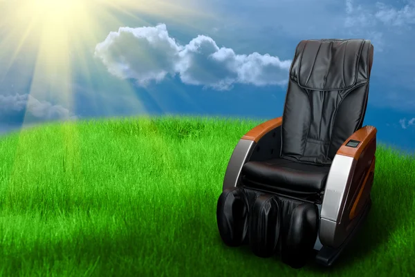 Massage arm-chair on the grass field — Stock Photo, Image