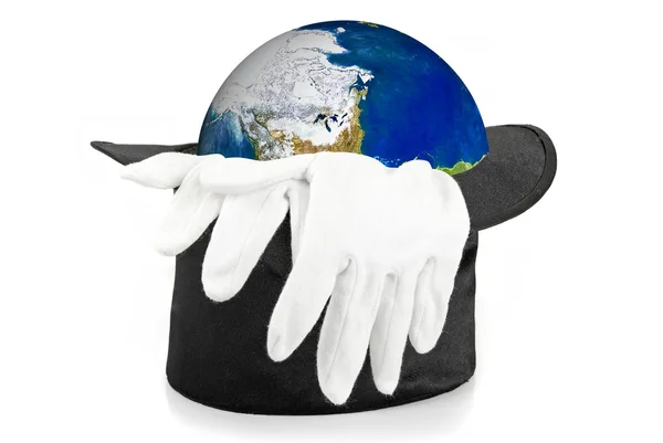 Black magic hat and gloves with earth — Stockfoto