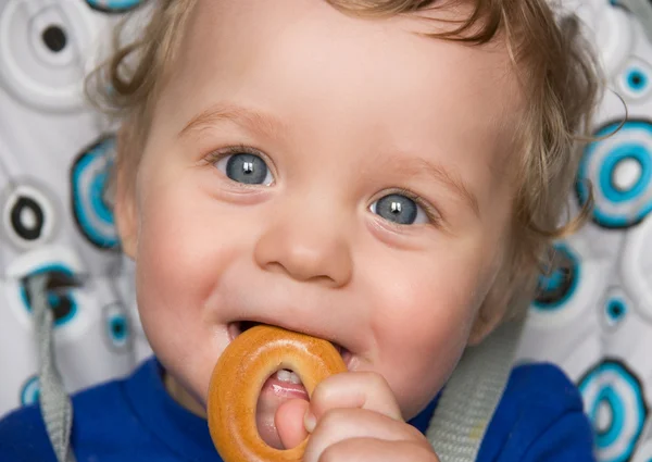 Baby boy with bread ring — Stock Photo, Image