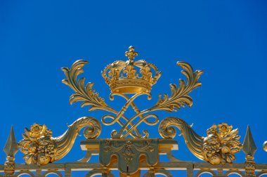 Detail of golden door of Versailles Palace under blue sky clipart