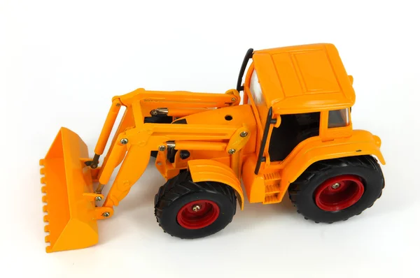 stock image Yellow tractor toy on a white