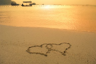 Two hearts drawn in beach clipart