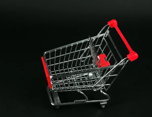 Shopping carts over black background — Stock Photo, Image