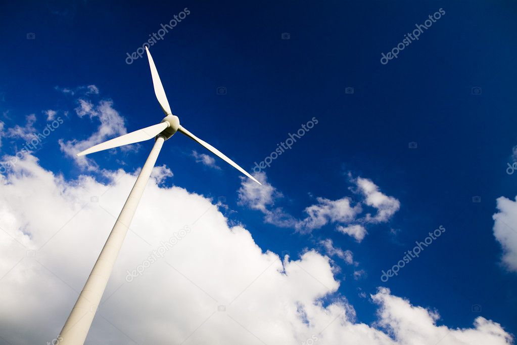 Windmills against a blue sky, clouds