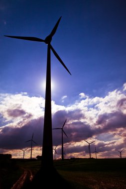 Windmills against a cloudy sky clipart