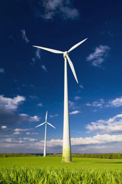 Windmills against a blue sky clipart
