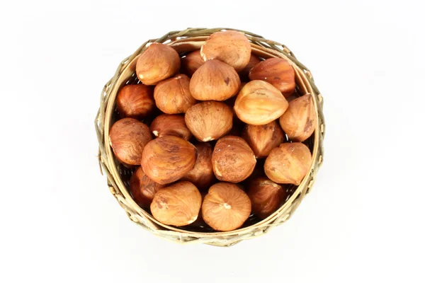 Hazelnuts in a round basket — Stock Photo, Image