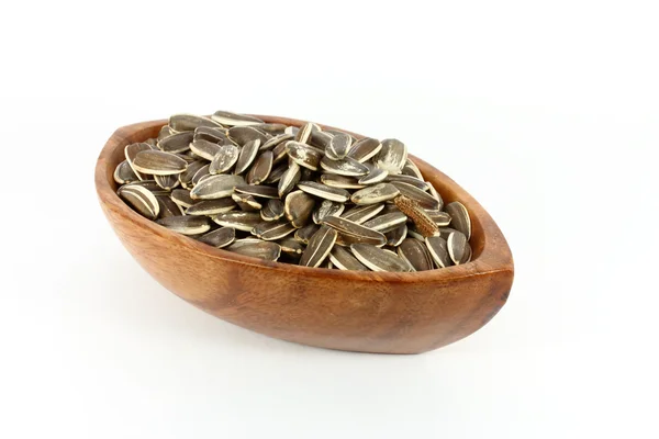 Sunflower seeds in a wood bowl — Zdjęcie stockowe
