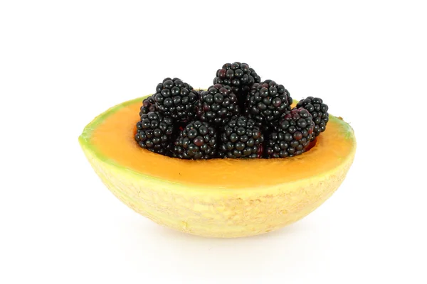 Blackberries in melon — Stock Photo, Image