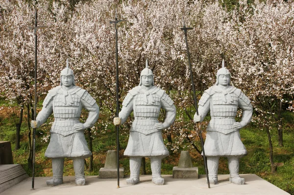 Chinese terra cotta warriors in the pear flower woods. — Stock Photo, Image