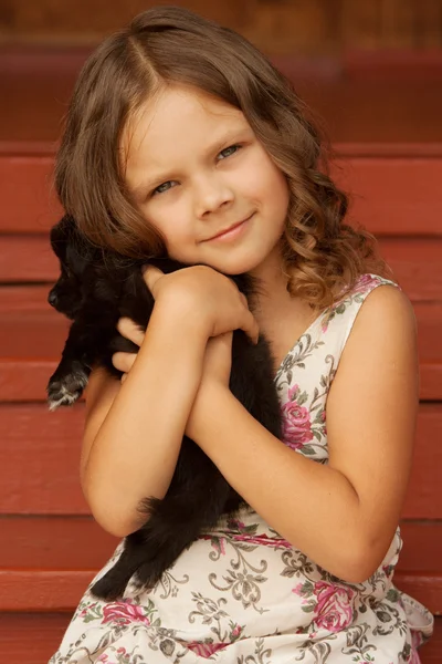 stock image Girl hugging puppy