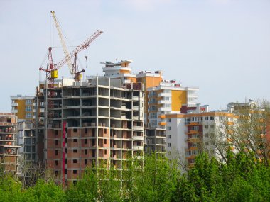 New house construction view with cranes clipart