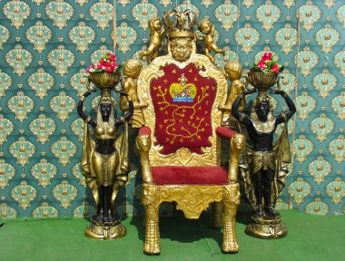 Vintage luxury throne chair with two egyptian statues clipart