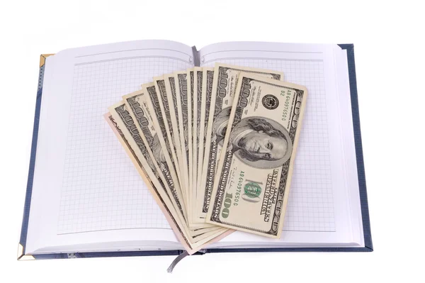 Opened notebook with dollars banknotes — Stock Photo, Image