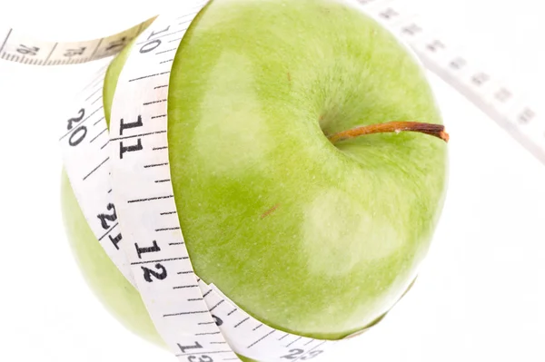 Green apple measured the meter — Stock Photo, Image