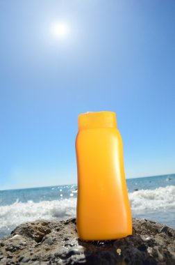 Tube with sun protection on beach of ocean clipart