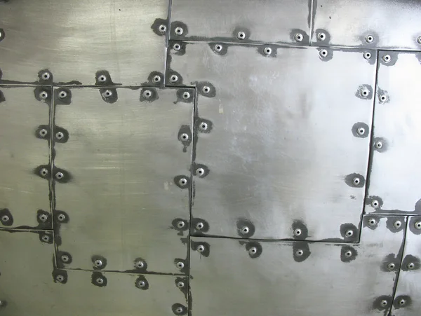 Metalen oppervlak met klinknagels. zilveren achtergrond — Stockfoto