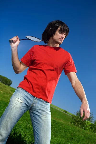 Boy in jeans with racket — Stock Photo, Image