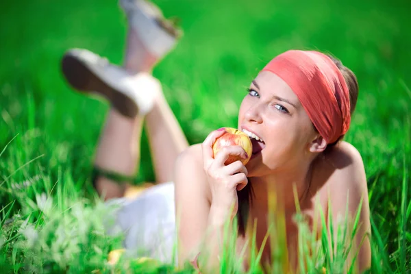 Girl in kerchief with apple — Stock Photo, Image