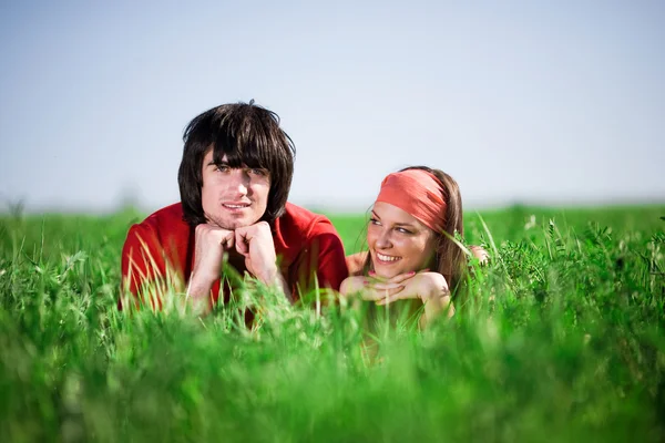 Çimenlerin üzerinde gülümseyen kız ve erkek — Stok fotoğraf