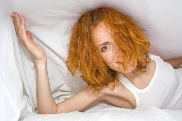 Dishevelled woman in bed — Stock Photo, Image