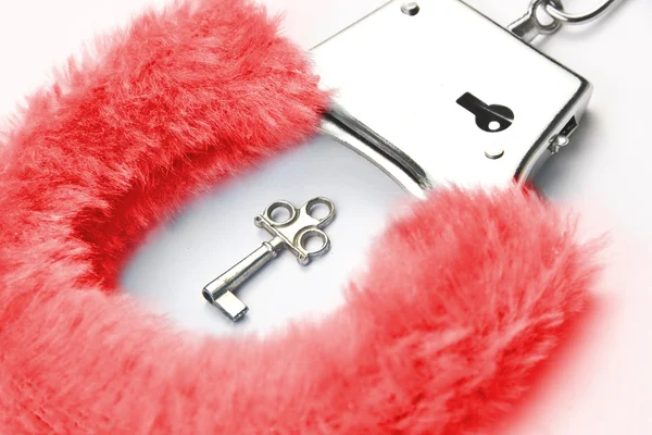 Red fluffy handcuffs — Stock Photo, Image