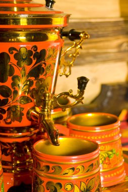 Traditional russian samovar with cups clipart