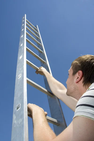 Man climbing ladder Royalty Free Stock Images