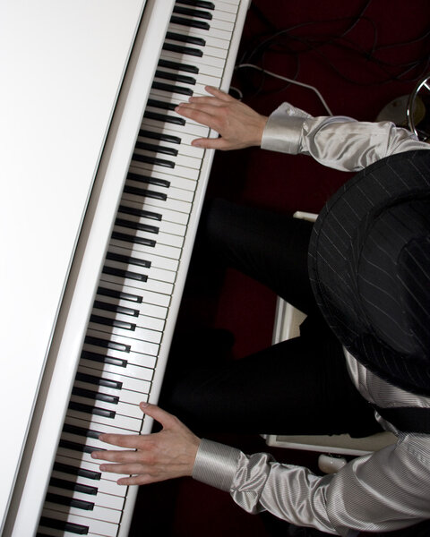 Playing the piano. Fingers at keypad