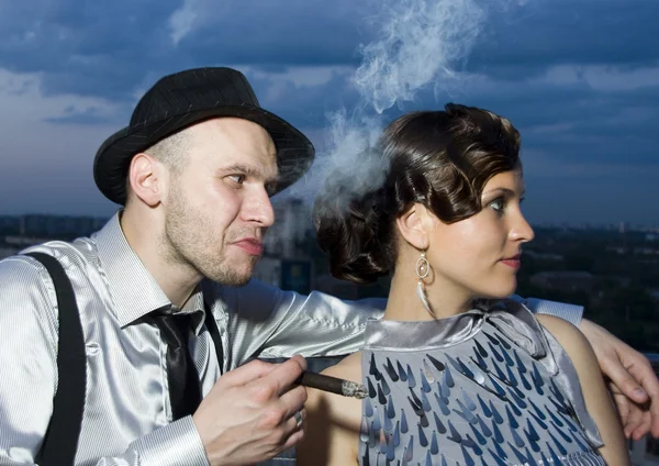 Smoking impudent gangster with retro girl — Stock Photo, Image