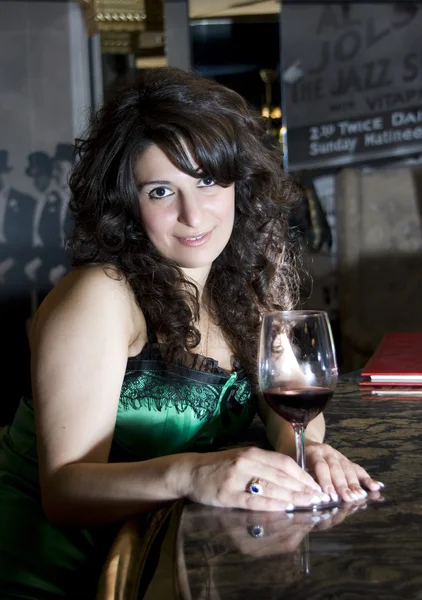 Flirting woman at bar with wineglass — Stock Photo, Image