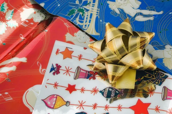 Golden ribbon on wrapping paper — Stock Photo, Image