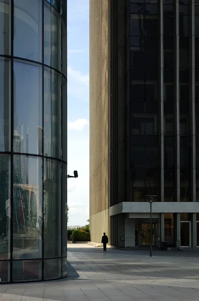 stock image Lonely silhouette passing by skyscrapers