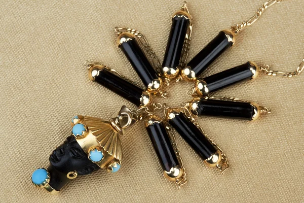 Ornament from gold and black onyx — Stock Photo, Image