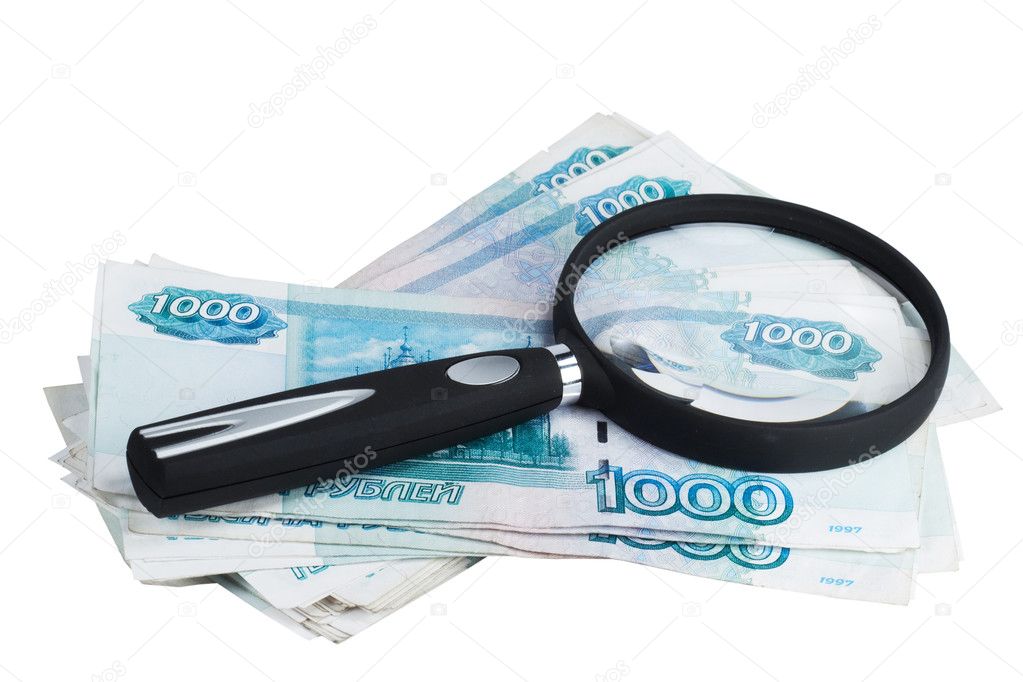 Russian money roubles and magnifying glass
