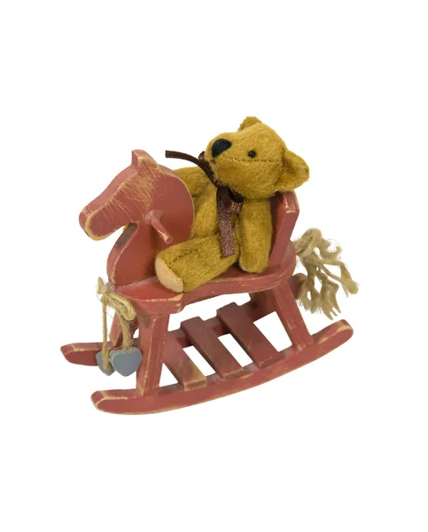 Urso de pelúcia em um cavalo de balanço pintado — Fotografia de Stock