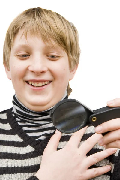 A boy and a magnifying glass — Stock Photo, Image