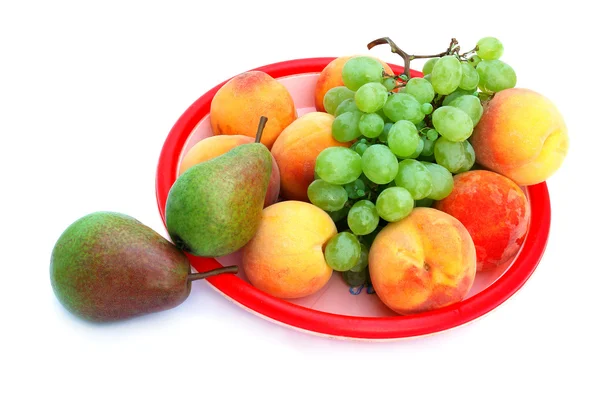 Grapes, peaches and pears in the tray — Stock Photo, Image