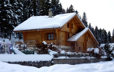 Chalet in Jura mountain by winter clipart