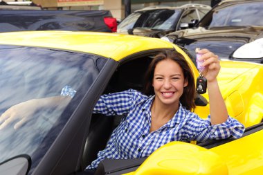 Woman showing keys of her new sports car clipart