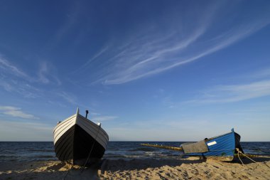 Fishing boats on the beach clipart